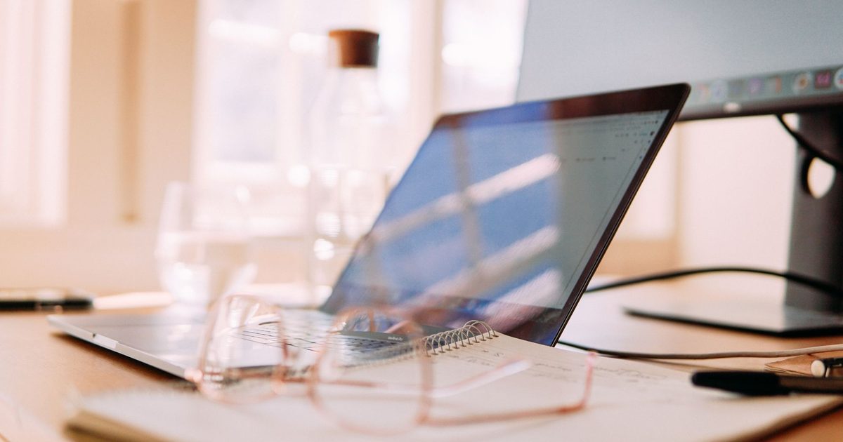 Home office desk with a laptop and monitor - does your website need a redesign